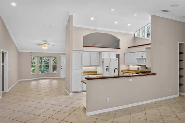 a view of livingroom with kitchen island hardwood floor and ceiling fan