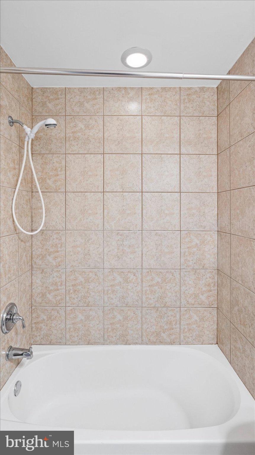 847 Carroll Street Baltimore, MD 21230 - Photo 19 of 33 Modern tiled shower with sleek tub.