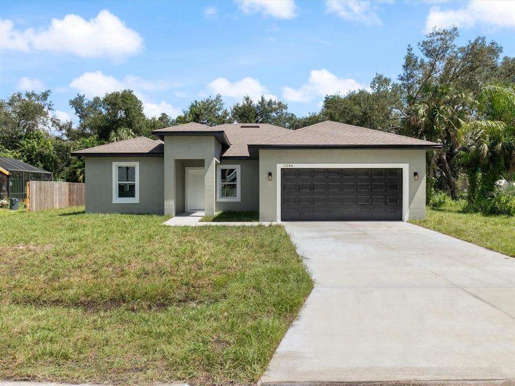 1246 Ramsdel Street Port Charlotte, FL 33952 - Photo 1 of 1 front view of a house with a yard