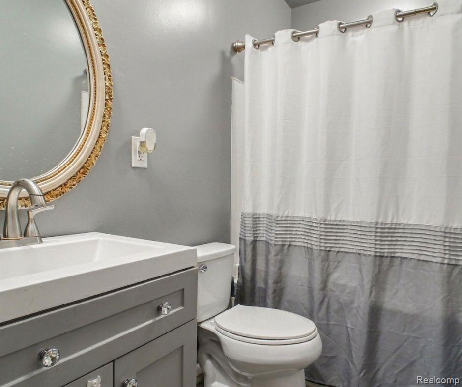 5082 North Center Road Flint, MI 48506 - Photo 6 of 21 Vanity with an integrated sink, brushed nickel faucet, and crystal knob hardware