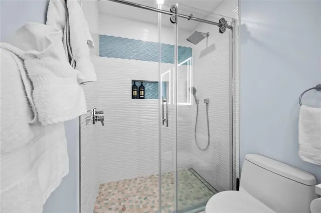 a bathroom with a shower toilet and sink