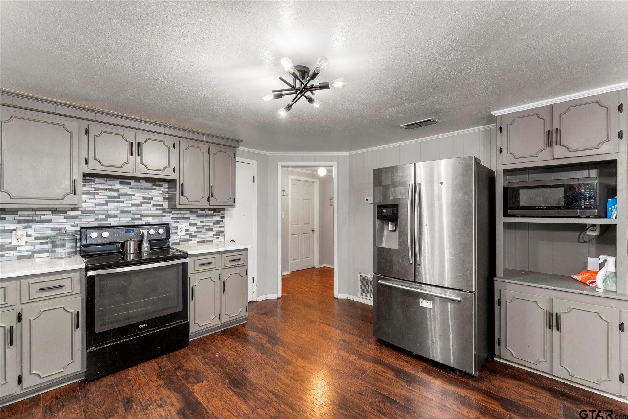 1108 Merritt Avenue Mount Pleasant, TX 75455 - Photo 10 of 17 a kitchen with granite countertop a refrigerator stove and oven