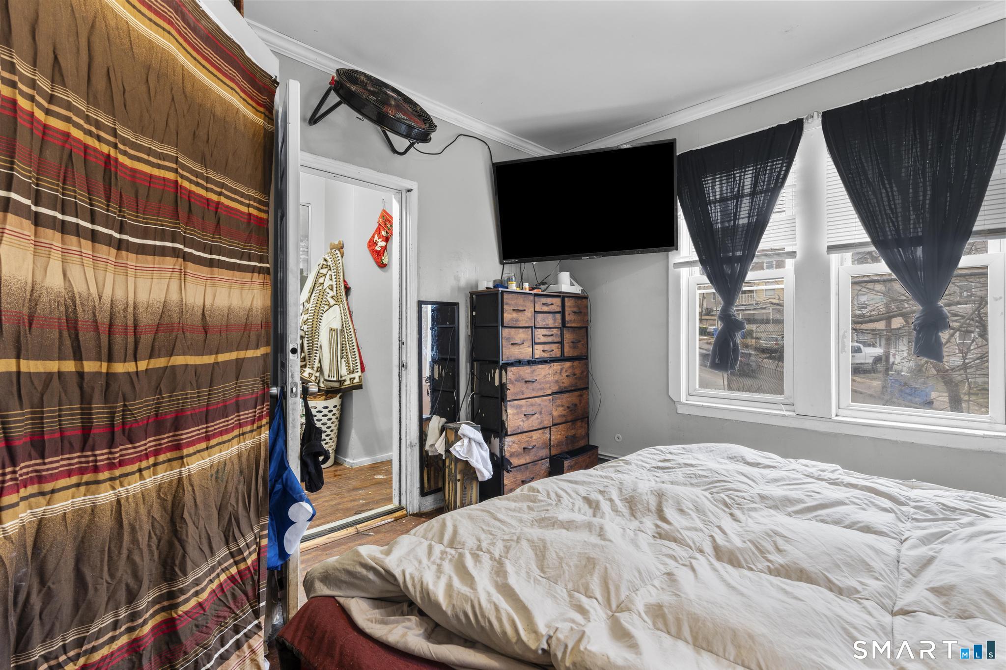 103 Walnut Street Waterbury, CT 06704 - Photo 11 of 38 a bedroom with furniture and a flat screen tv