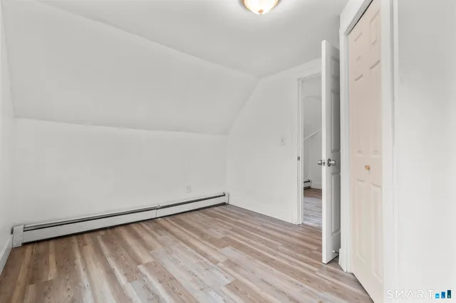 an empty room with wooden floor