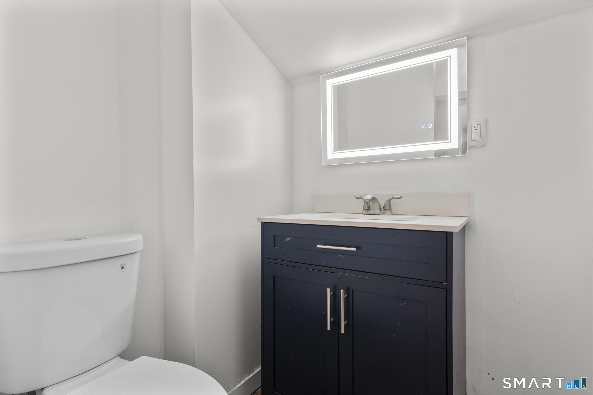 103 Walnut Street Waterbury, CT 06704 - Photo 23 of 38 a bathroom with a sink toilet and mirror