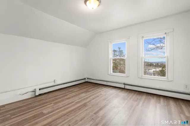 an empty room with wooden floor and closet
