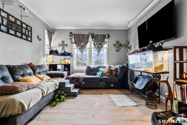 a bedroom with furniture and a flat screen tv