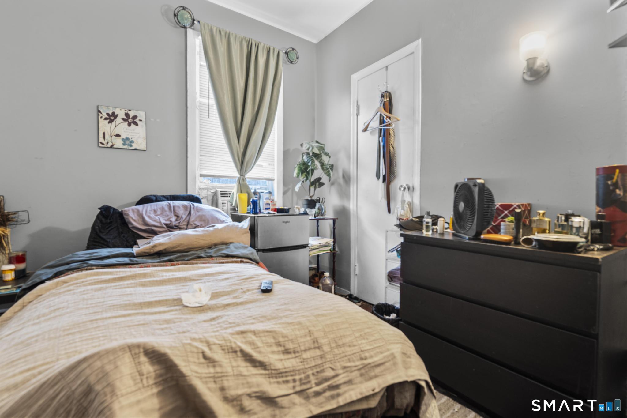 103 Walnut Street Waterbury, CT 06704 - Photo 6 of 38 a bedroom with a bed and a window