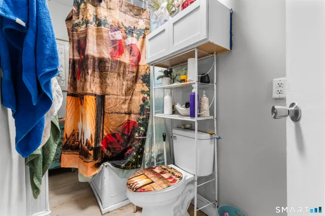 a bed sitting in a bedroom and night stand