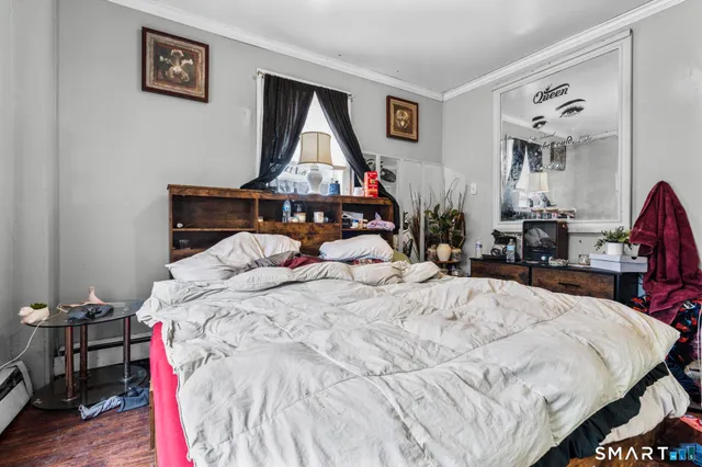a bedroom with furniture and a flat screen tv