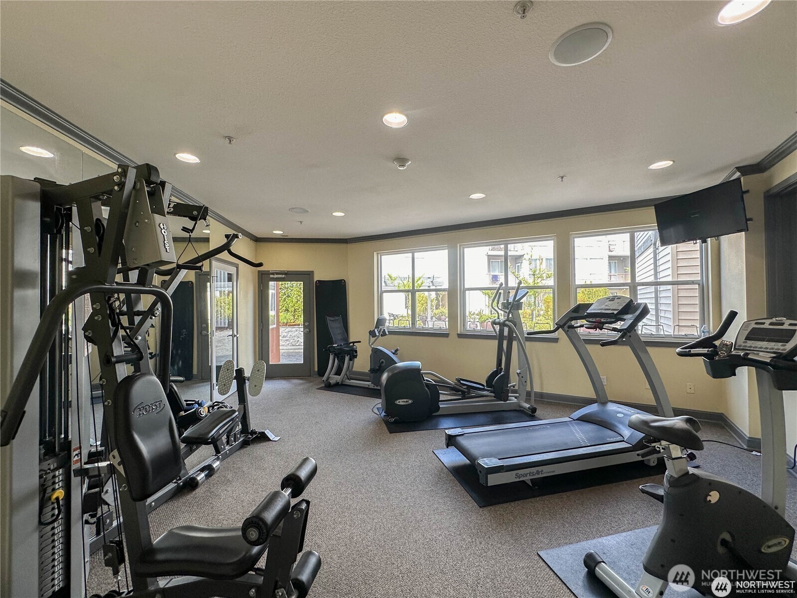 225 Logan Avenue South, Unit 111 Renton, WA 98057 - Photo 31 of 33 a room with gym equipment and large mirror
