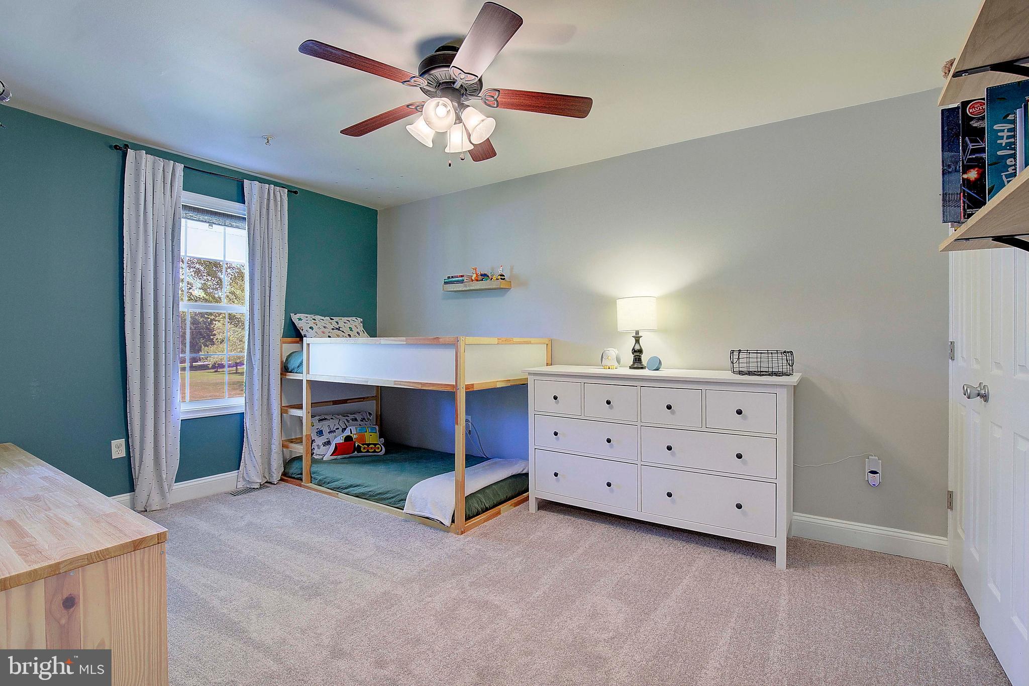 7006 Prout Road Friendship, MD 20758 - Photo 25 of 48 a bedroom with a bed and a chandelier