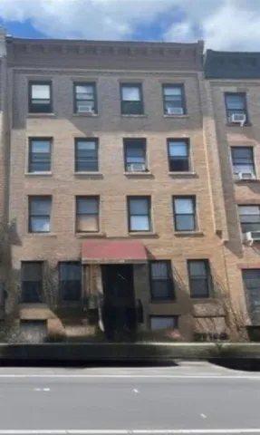 a view of a brick house with windows