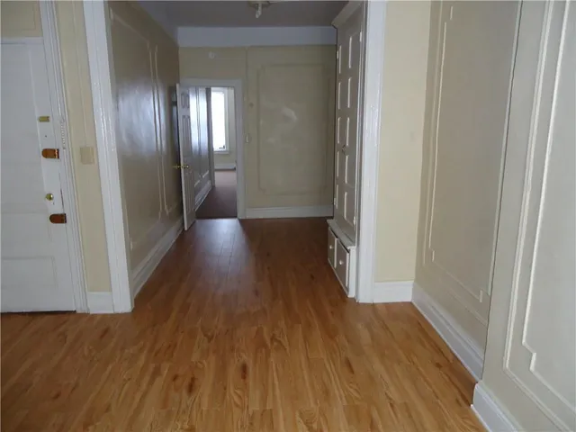 a view of a hallway with wooden floor