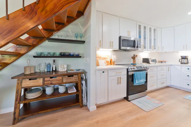 a kitchen with stainless steel appliances granite countertop a stove and a sink