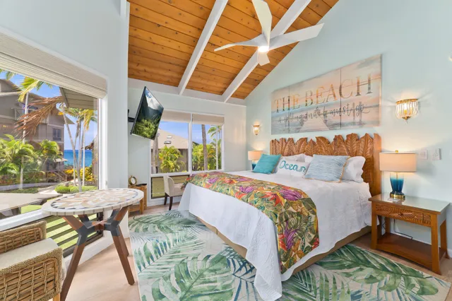 a bedroom with a bed a desk and chair with the wooden floor