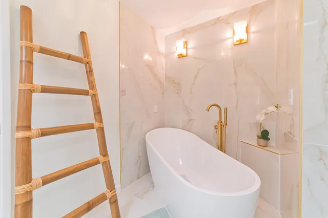 a white bath tub sitting next to a white sink