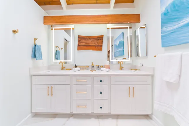 a bathroom with a sink vanity and mirror