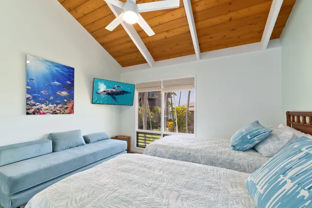 a bedroom with a large bed and a painting on the wall