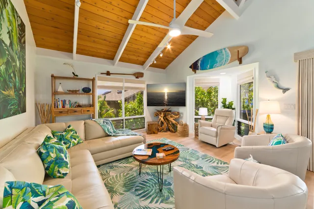 a living room filled with furniture and floor to ceiling window