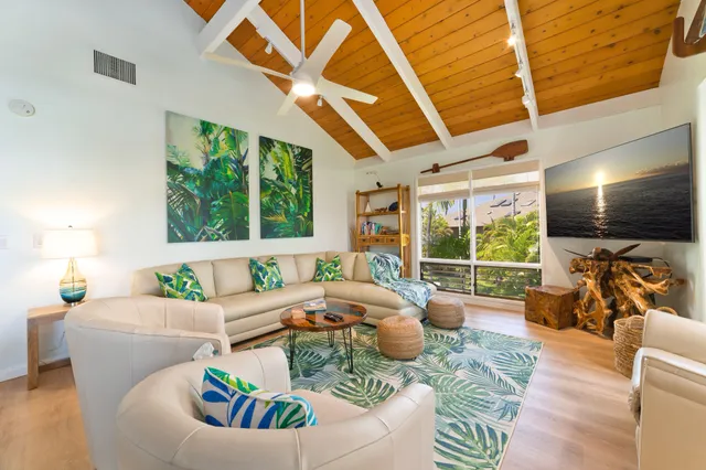 a living room with fireplace furniture and a large window