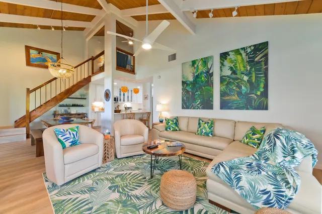 a living room with furniture and a potted plant