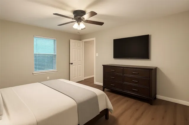 a bedroom with a bed and a flat screen tv