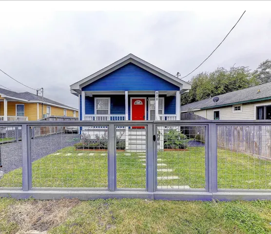 a view of house with backyard outdoor seating and deck