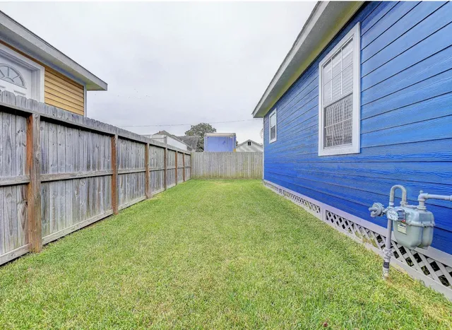 a view of a backyard with wooden fence