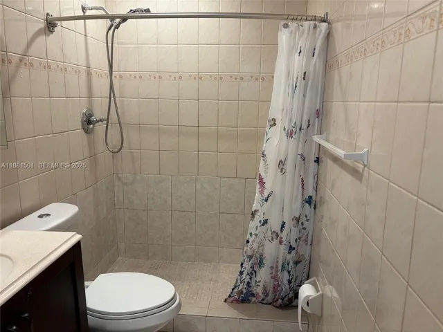 a bathroom with a toilet and shower