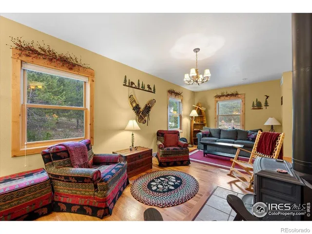 a living room with furniture a rug and a chandelier