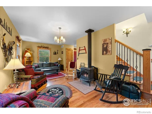 a living room with furniture a rug and a chandelier
