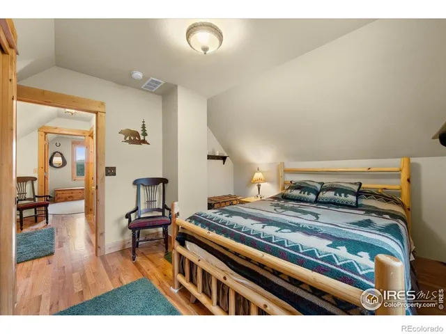 a bedroom with furniture and a wooden floor