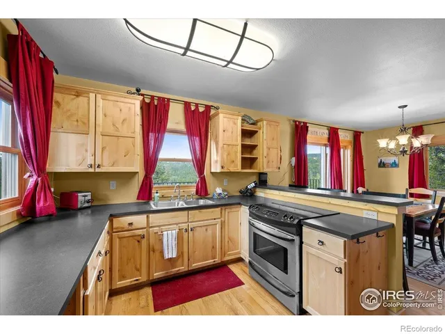 a kitchen with stainless steel appliances kitchen island granite countertop a stove and a sink