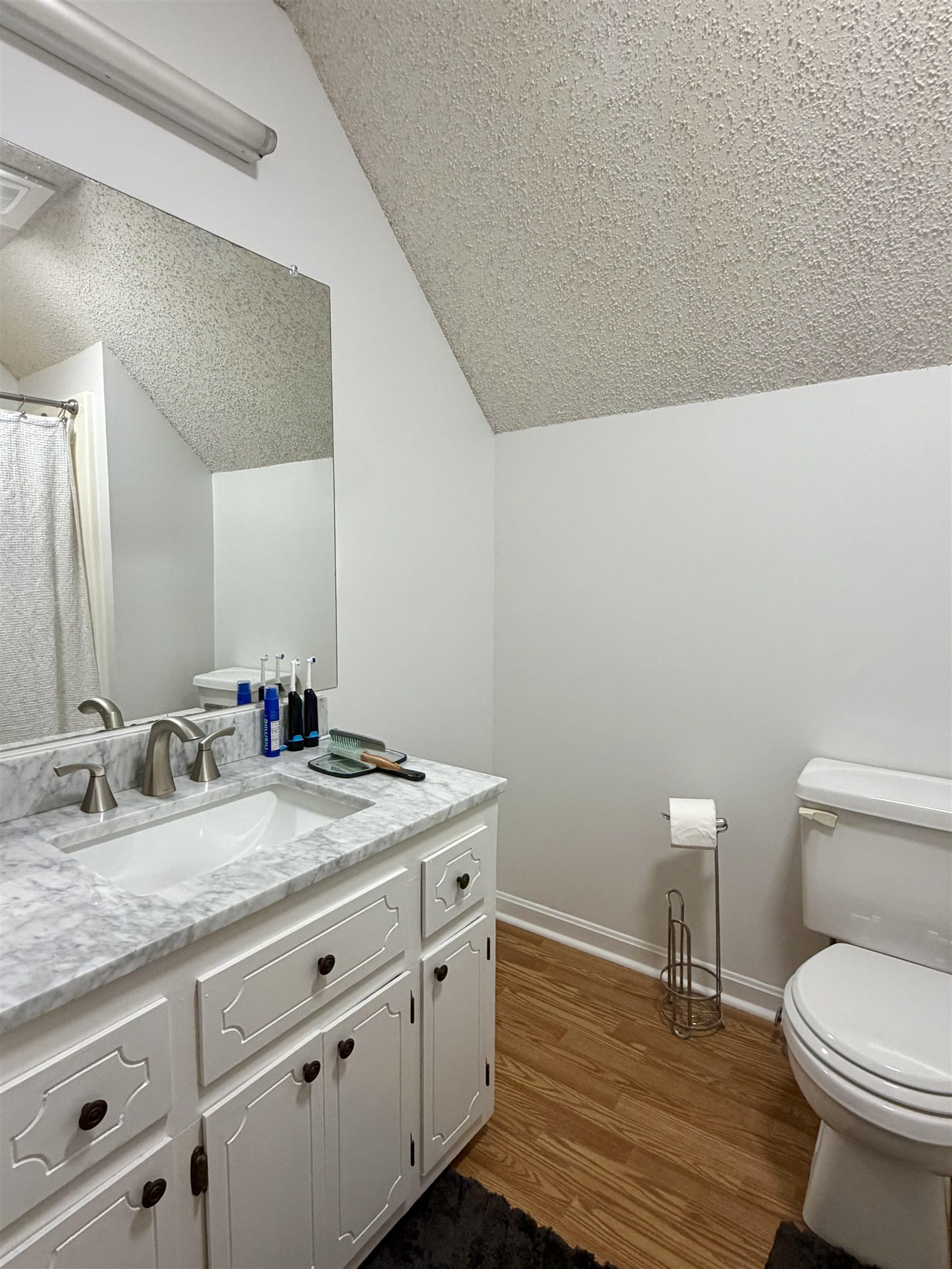 142 Treece Street Selmer, TN 38375 - Photo 19 of 36 Bathroom featuring a white vanity with a light-toned countertop, an integrated sink, and brushed nickel fixtures