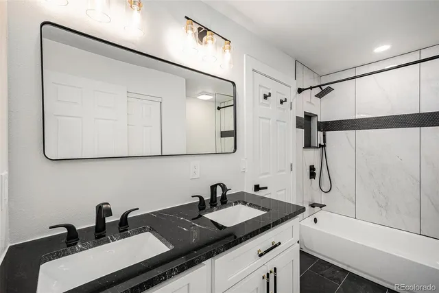 a bathroom with a double vanity sink a mirror and shower