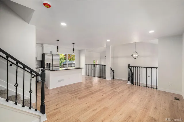 a view of kitchen with wooden floor and electronic appliances