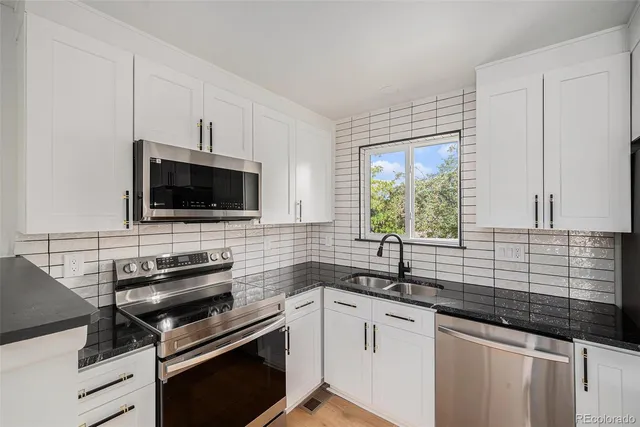 a kitchen with a sink stove and microwave