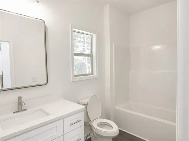 a bathroom with a sink toilet and bathtub