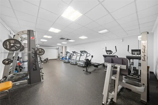 a room with furniture pool table and windows