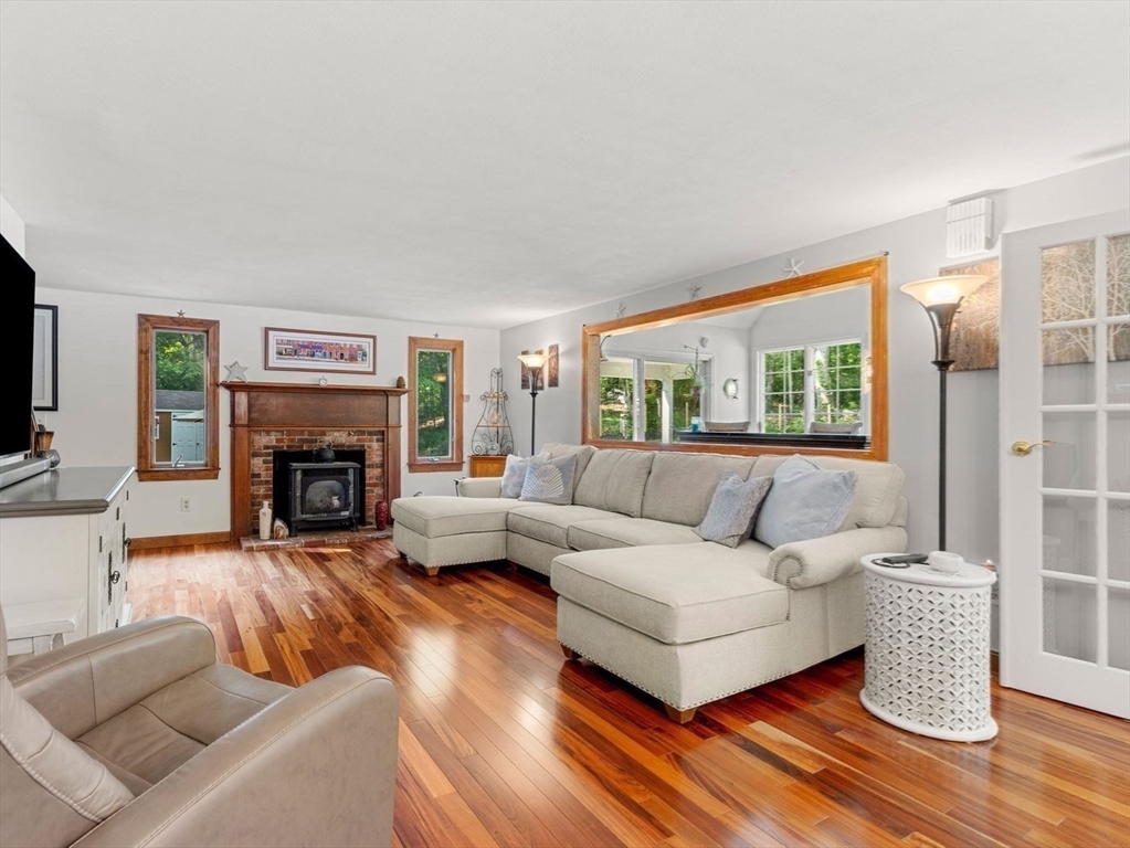 115 Depot Road Boxford, MA 01921 - Photo 12 of 40 a living room with furniture a large window and a fireplace