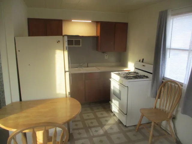 a kitchen with cabinets and chairs