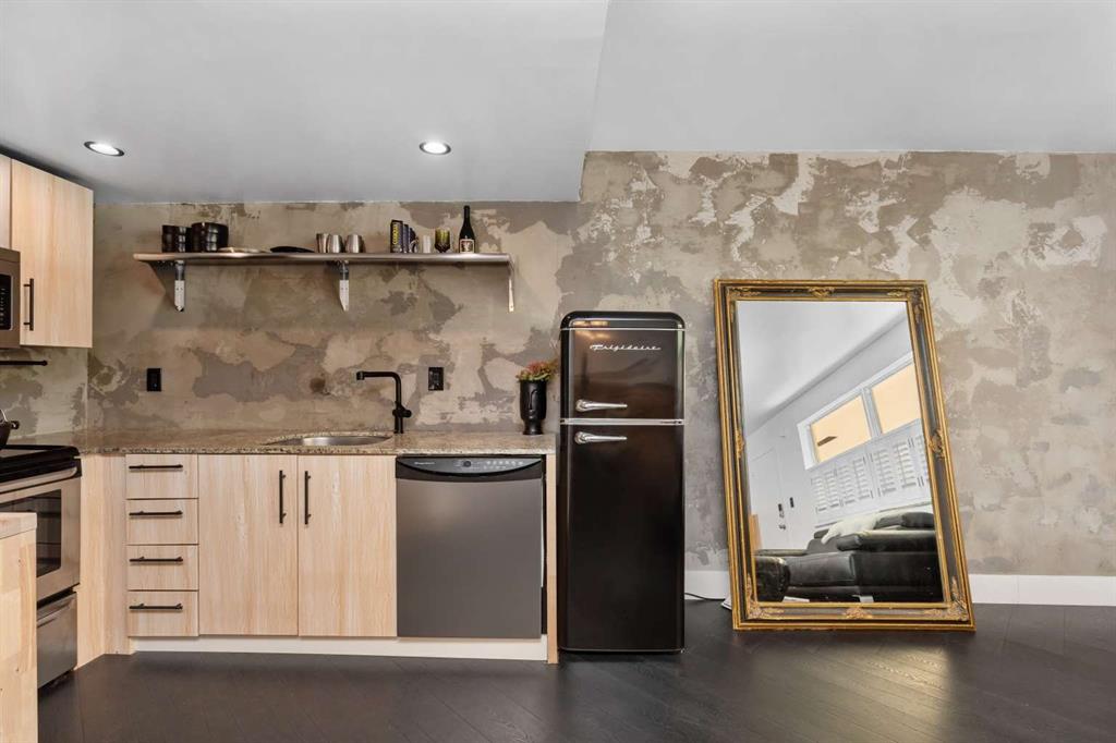a kitchen with stainless steel appliances granite countertop a refrigerator and a stove