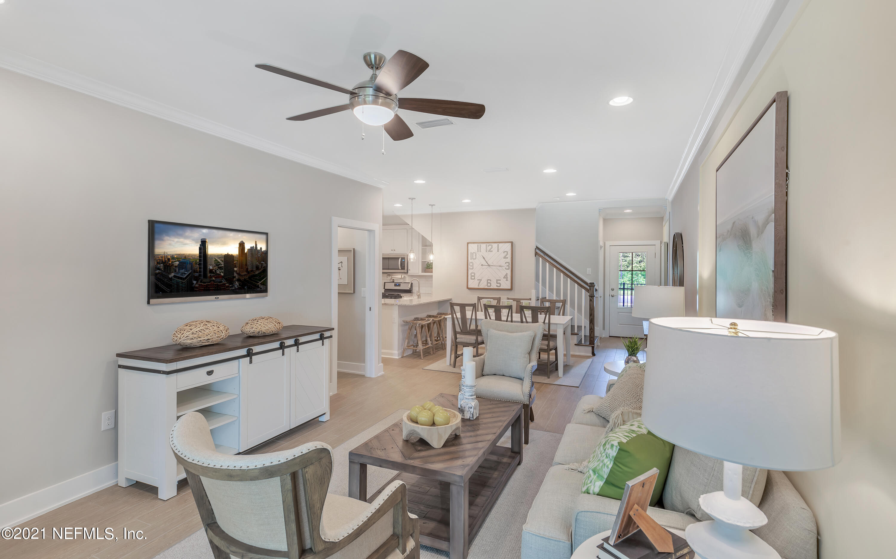 236 Charlie Way St. Augustine, FL 32095 - Photo 11 of 24 a living room with furniture a ceiling fan and a flat screen tv