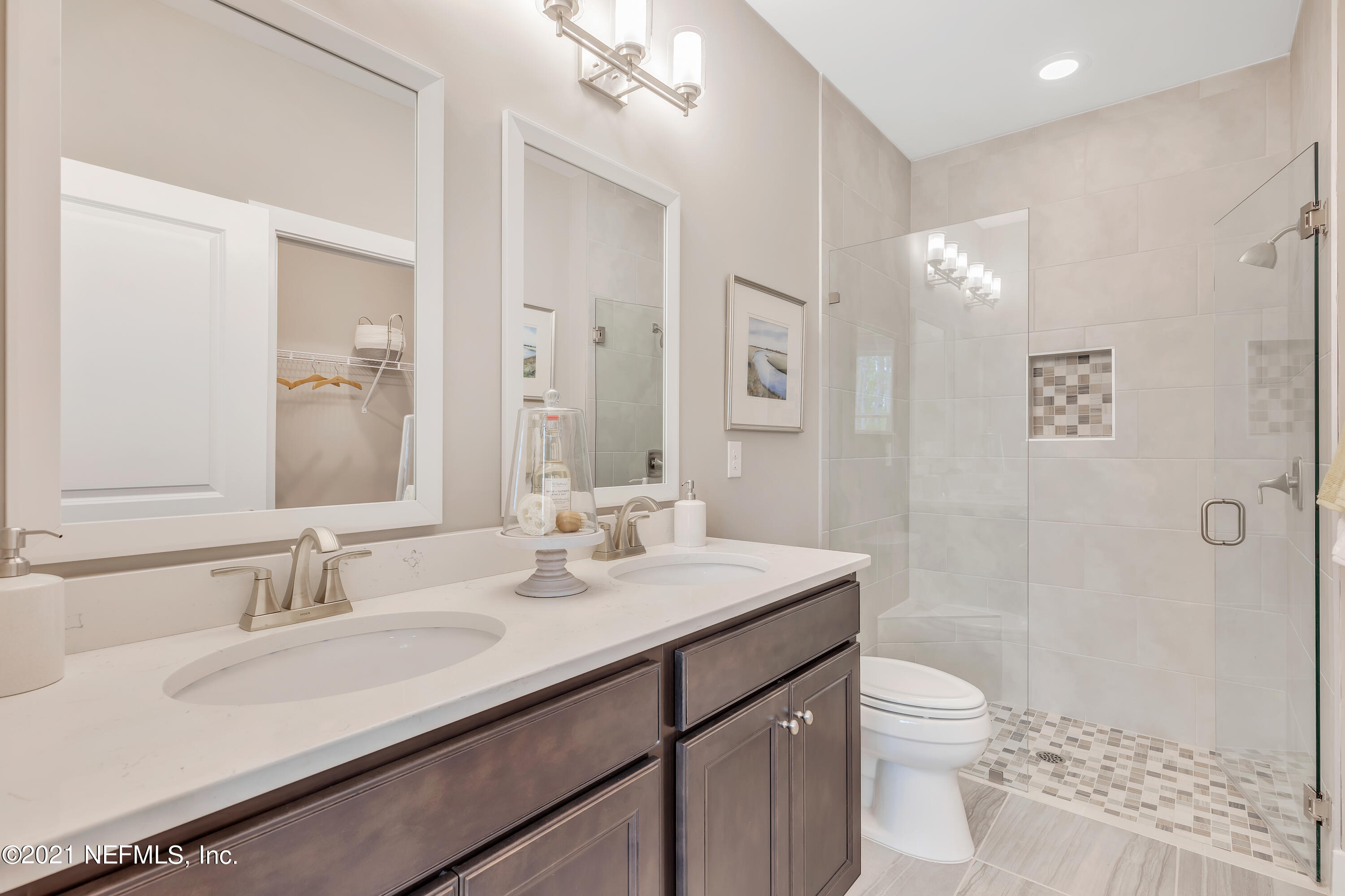 236 Charlie Way St. Augustine, FL 32095 - Photo 16 of 24 a bathroom with a sink a toilet a shower and a mirror