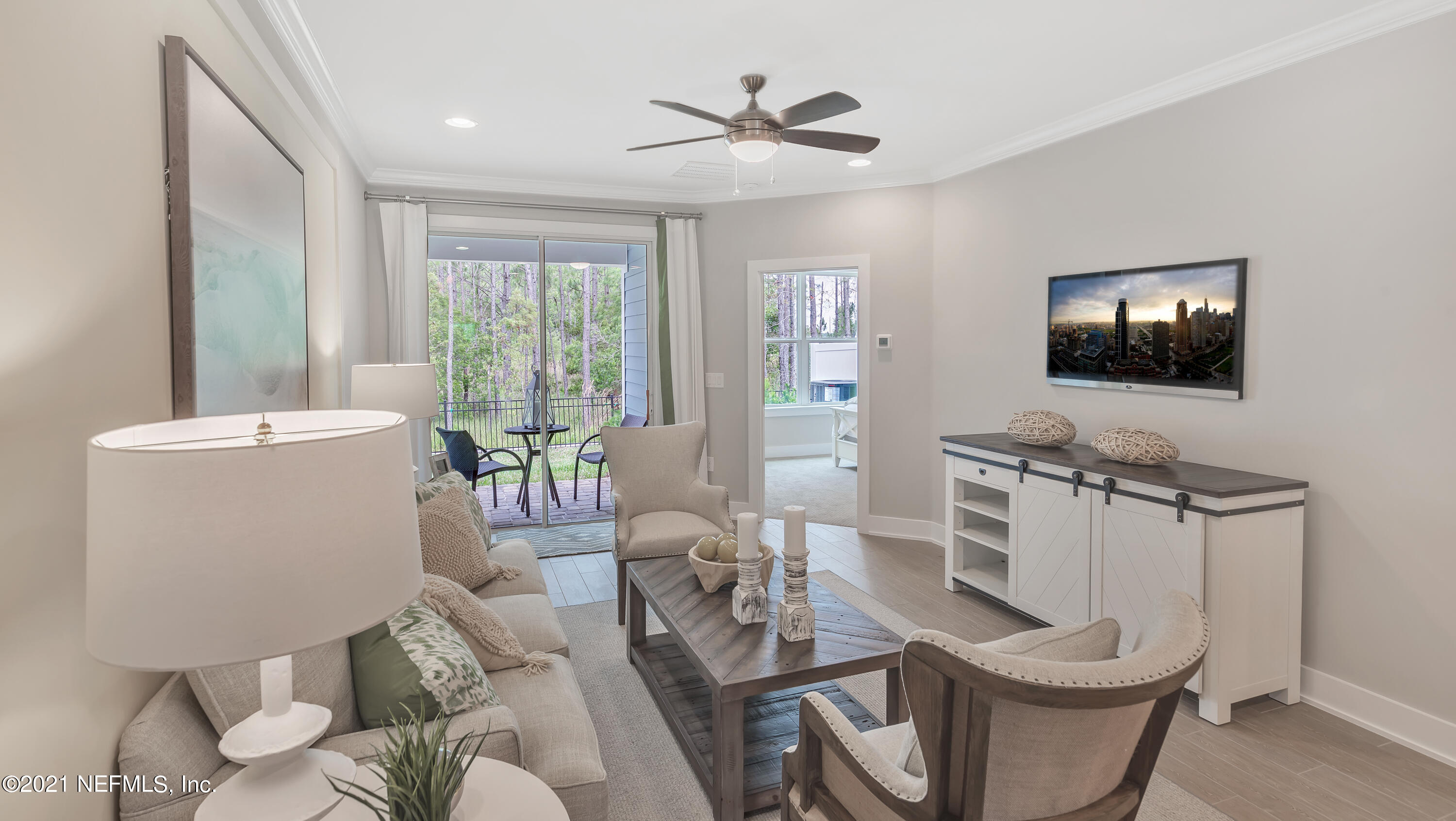 236 Charlie Way St. Augustine, FL 32095 - Photo 9 of 24 a living room with furniture a flat screen tv and a large window