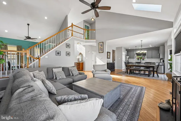 a living room with furniture and kitchen view