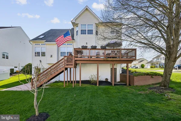 a view of a house with a backyard and a patio