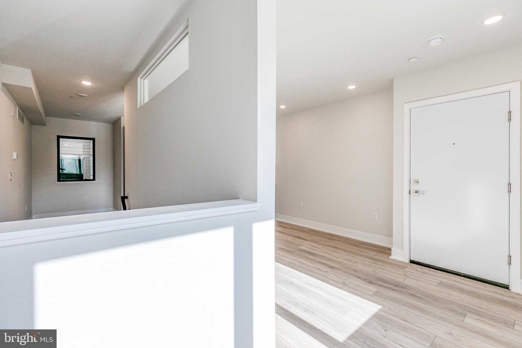 1506 North 8th Street, Unit 1 Philadelphia, PA 19122 - Photo 11 of 18 a view of a hallway with wooden floor and staircase