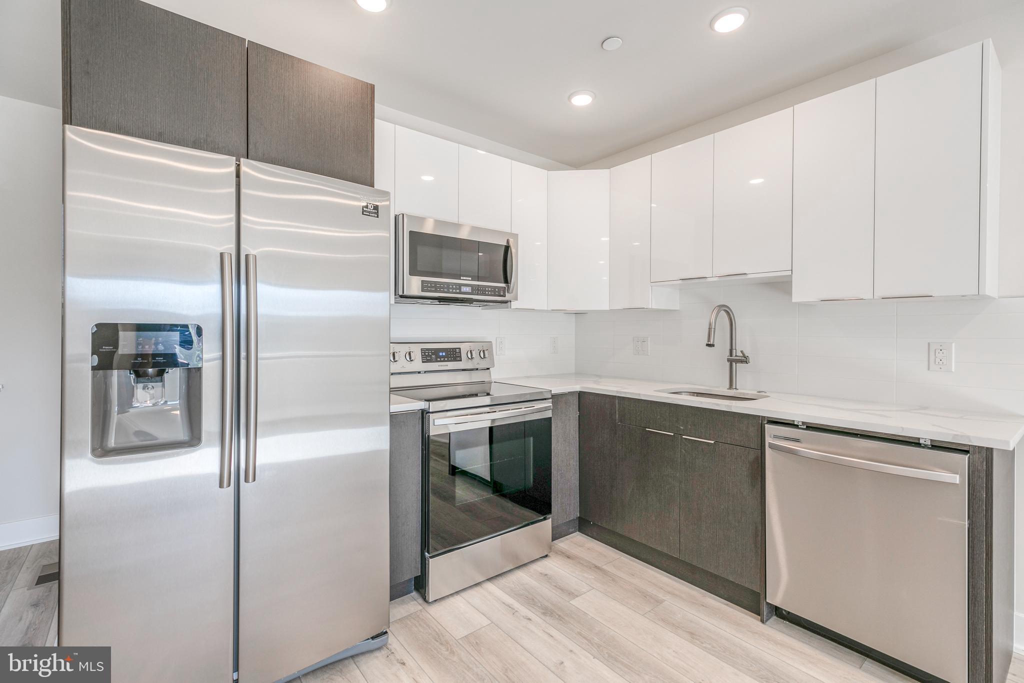 1506 North 8th Street, Unit 1 Philadelphia, PA 19122 - Photo 2 of 18 a kitchen with a refrigerator sink and microwave